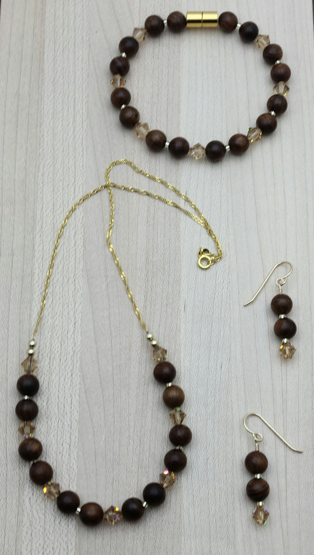 Rosewood is said to represent romantic love & sincere blessings. Paired with light light topaz crystals & gold, it is warm & inviting. necklace, bracelet, earrings