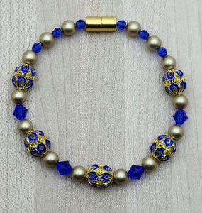 Brilliant blue & gold cloisonne beads, crystals* & crystal pearls* team up for an eye-catching bracelet  with magnetic clasp.