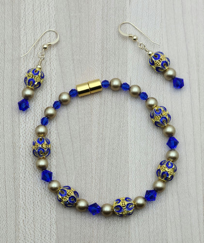 Brilliant blue & gold cloisonne beads, crystals* & crystal pearls* team up for an eye-catching bracelet & matching earrings.
