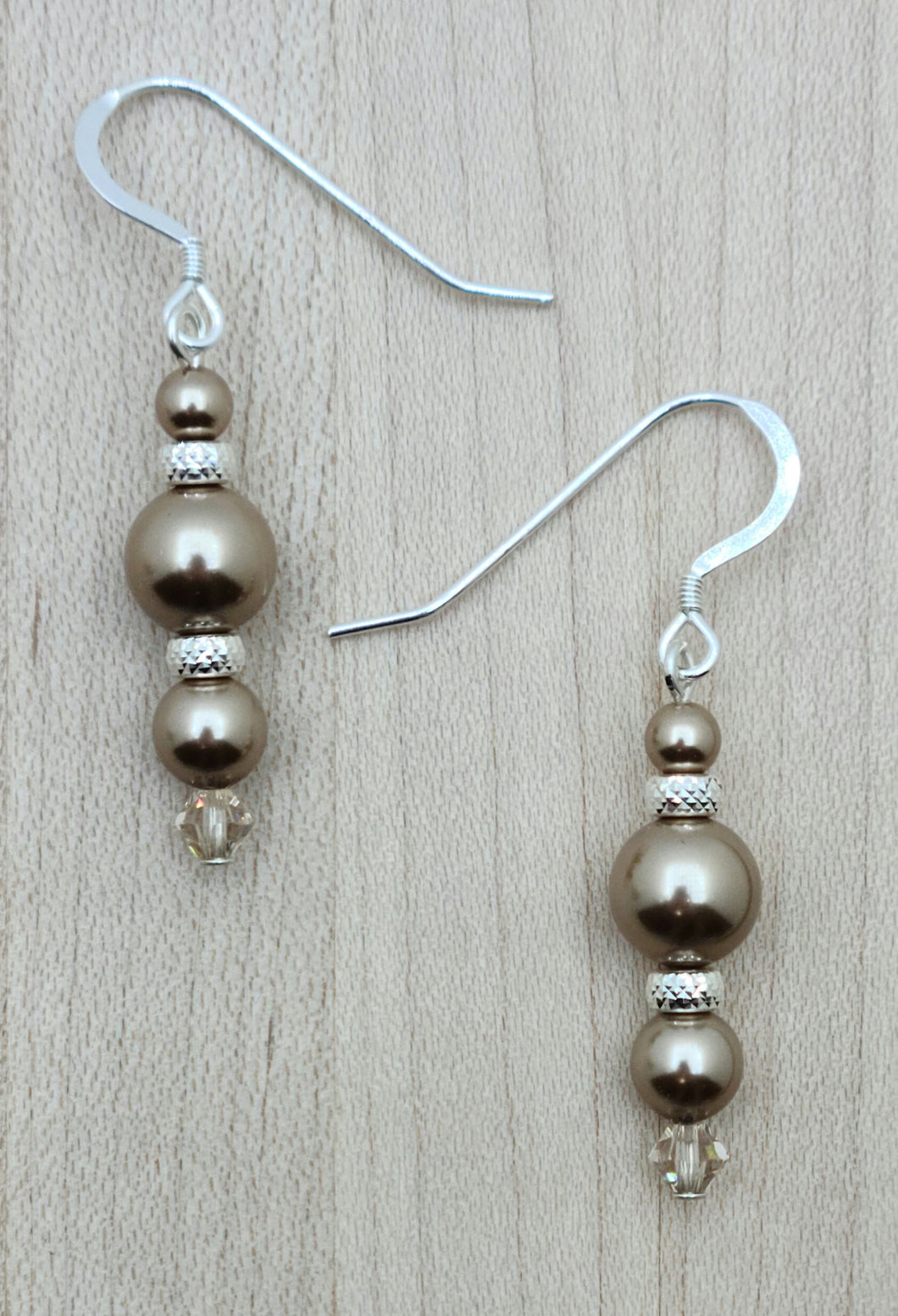 Beautiful bronze crystal pearls, pyramid cut sterling silver rondelles, & light silk crystals combine to create very elegant earrings!