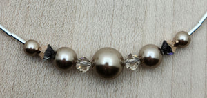 These bronze crystal pearls coupled with crystals of light silk and rose gold are so very elegant & stunning!