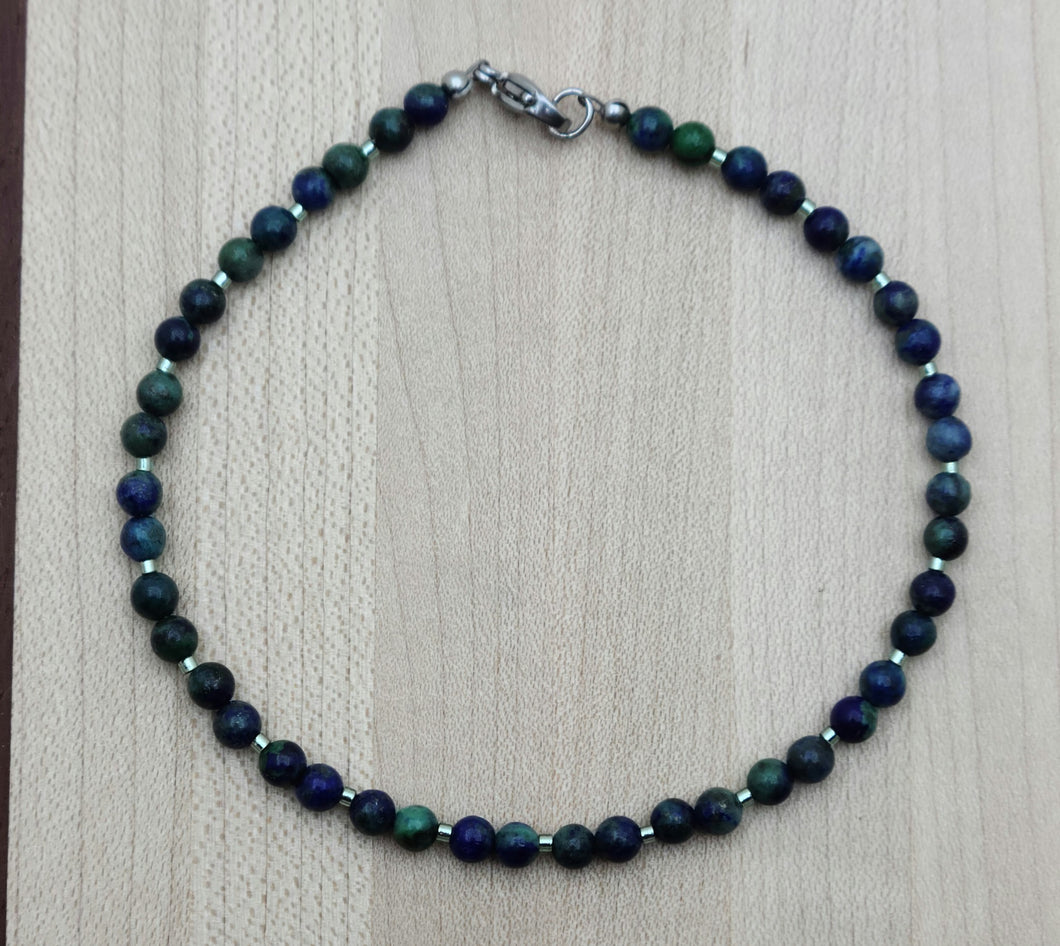 Dress up your ankle with a lovely, eye-catching anklet of stones comprised of blue azurite & hints of green malachite!