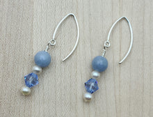 Angelite, or angel stone, is a soft blue that fits perfectly with light sapphire crystals, long fish hook earrings