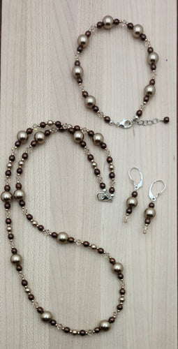 This is a gorgeous combination of bronze crystal pearls, rose gold color electroplated hematite, light silk crystals, & galvanized champagne Miyuki seed beads in a crystal jewelry set of necklace, bracelet, & earrings. 