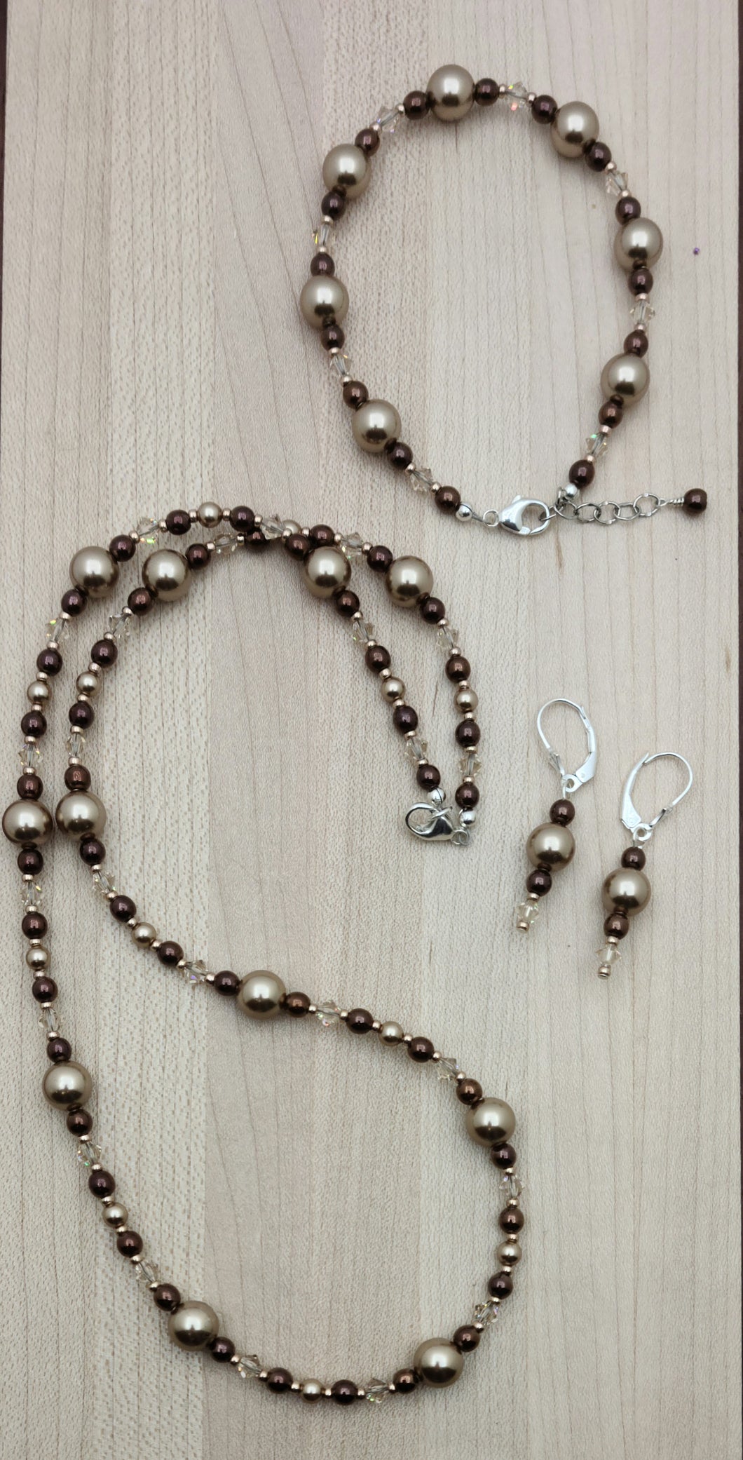 This is a gorgeous combination of bronze crystal pearls, rose gold color electroplated hematite, light silk crystals, & galvanized champagne Miyuki seed beads in a crystal jewelry set of necklace, bracelet, & earrings. 