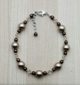 This is a gorgeous combination of bronze crystal pearls, rose gold color electroplated hematite, light silk crystals, & galvanized champagne Miyuki seed beads in a crystal jewelry bracelet