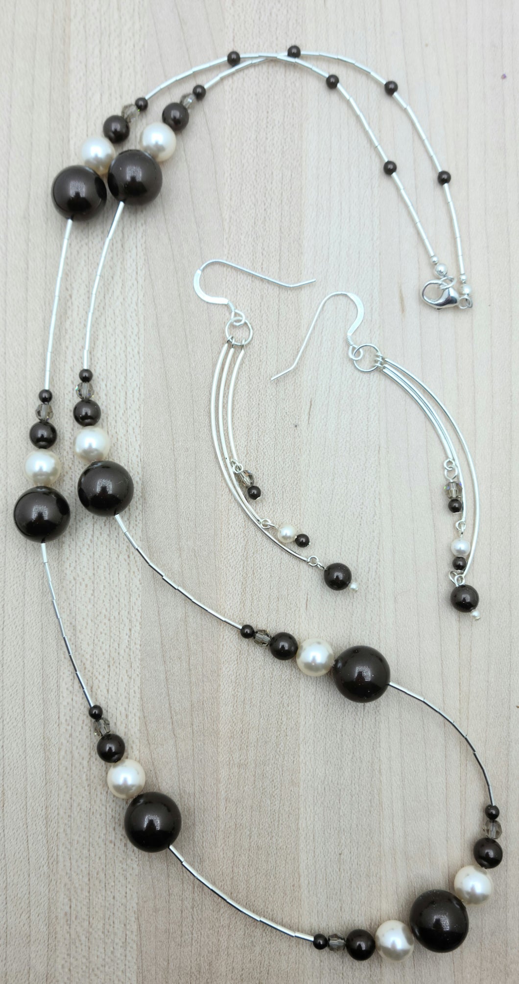 Chocolate & cream are the enticing stars in this necklace/earring set! Liquid sterling silver separate groups of crystal pearls & crystals!
