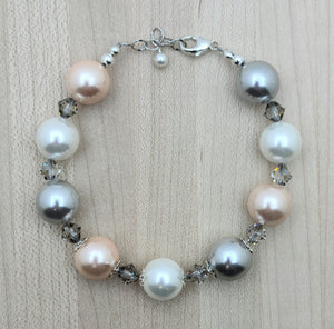 These large shell pearls of silver, white, & peach are SOOooo pretty! They're paired with lovely silver shade crystals. bracelet