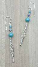 Fun 2 5/8", twisted sterling silver posts hang from the iridescent turquoise & azure crystal pearls & sterling silver fish hook ear wires.
