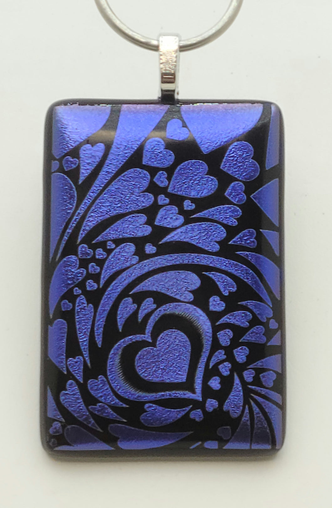 Swirling hearts surround a focal heart in this gorgeous etched purple dichroic glass statement fused glass pendant!