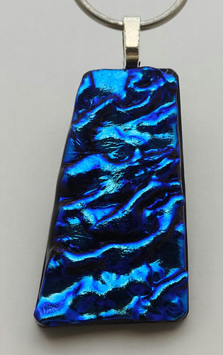 This gorgeous fused glass pendant is made from unltramarine blue textured ripple dichroic glass!