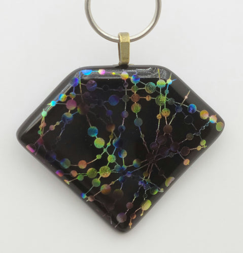 Colorful dots are strung together & randomly grouped in this fun etched dichroic fused glass pendant.