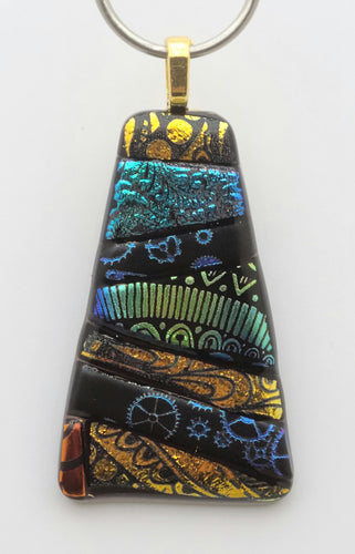 Gotta love the randomness of a crazy quilt. This is a fused glass pendant with a small sample in a delightful patchwork of etched dichroic glass!