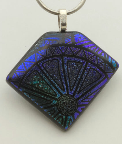 Call this etched dichroic fused glass pendant a citrus slice or a wheel - either works!