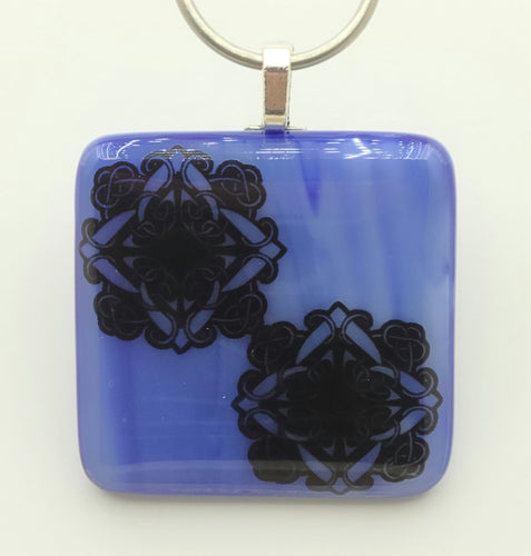 This streaky blue pendant is home to two elaborate Celtic knots.