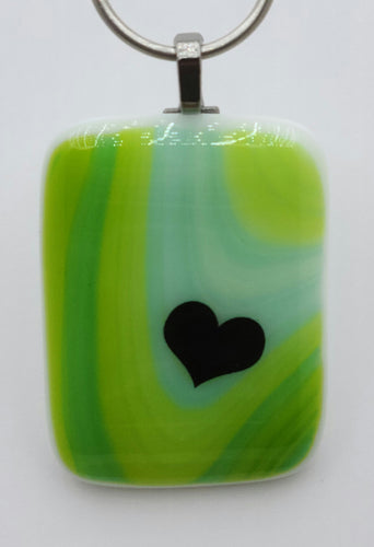 A heart nestles in the dip of aqua inside a green hued fused glass pendant!