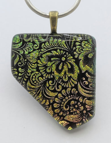 A gold & pink floral tapestry comes to mind with this clear clapped etched dichroic fused glass pendant.