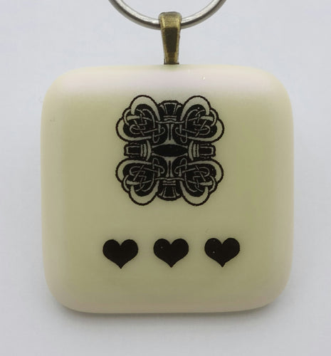 Celtic design hearts are featured over a pale lilac mica in this fused glass  pendant.