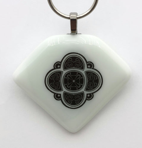 Pale mojito colored glass sports a Celtic knot design in this fused glass pendant!