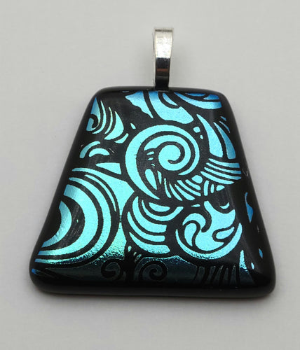 Striking swirls of teal adorn this etched dichroic fused glass pendant!