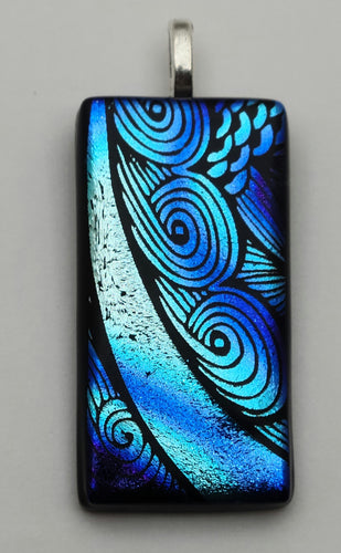 Cute curls in blue & silver shine in this etched dichroic fused glass pendant!