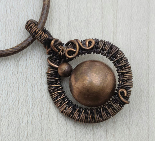 Antiqued copper wire & beads combine for a fun woven wire pendant.