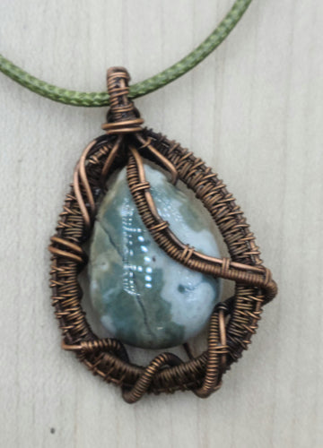 Antiqued copper wire & a green & cream agate stone combine for an interesting woven wire pendant.