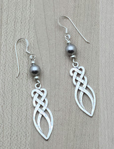 Silver crystal pearls* host a sterling silver endless weave knot in  these versatile earrings.