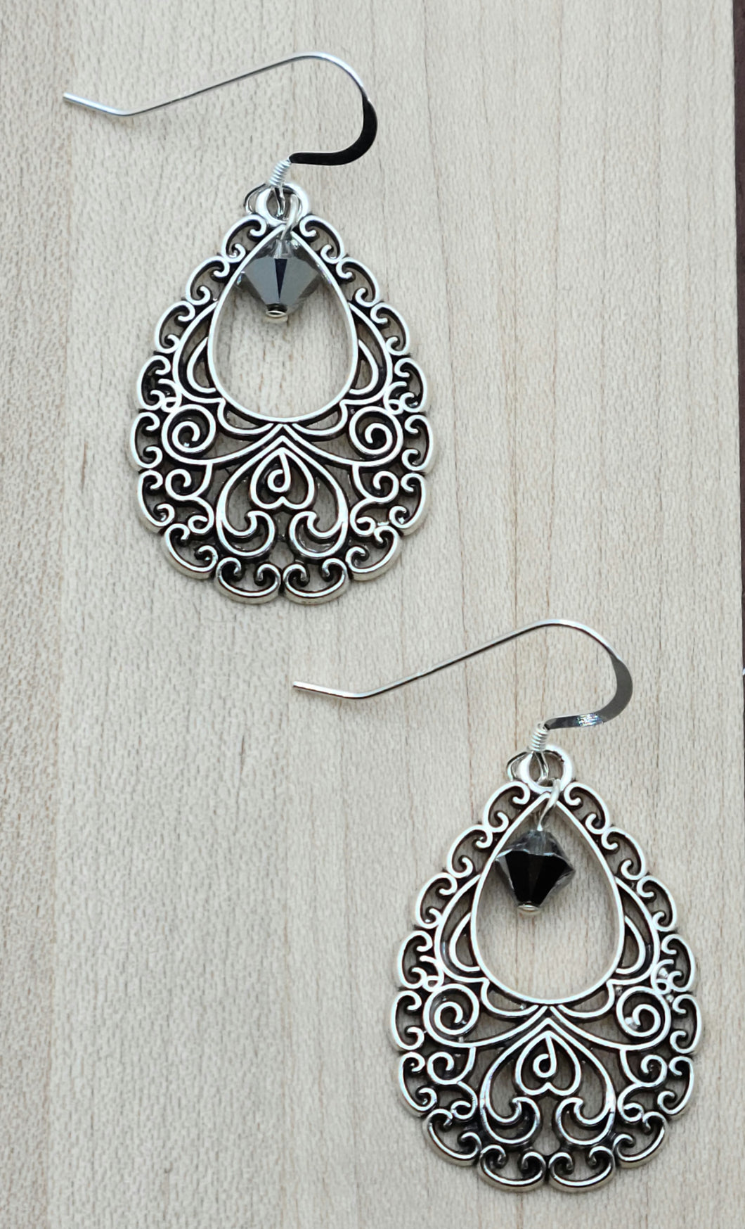 Lacy & lightweight, these pewter filigree teardrop earrings feature a single sparkling crystal 'blinging' from the center of each teardrop.