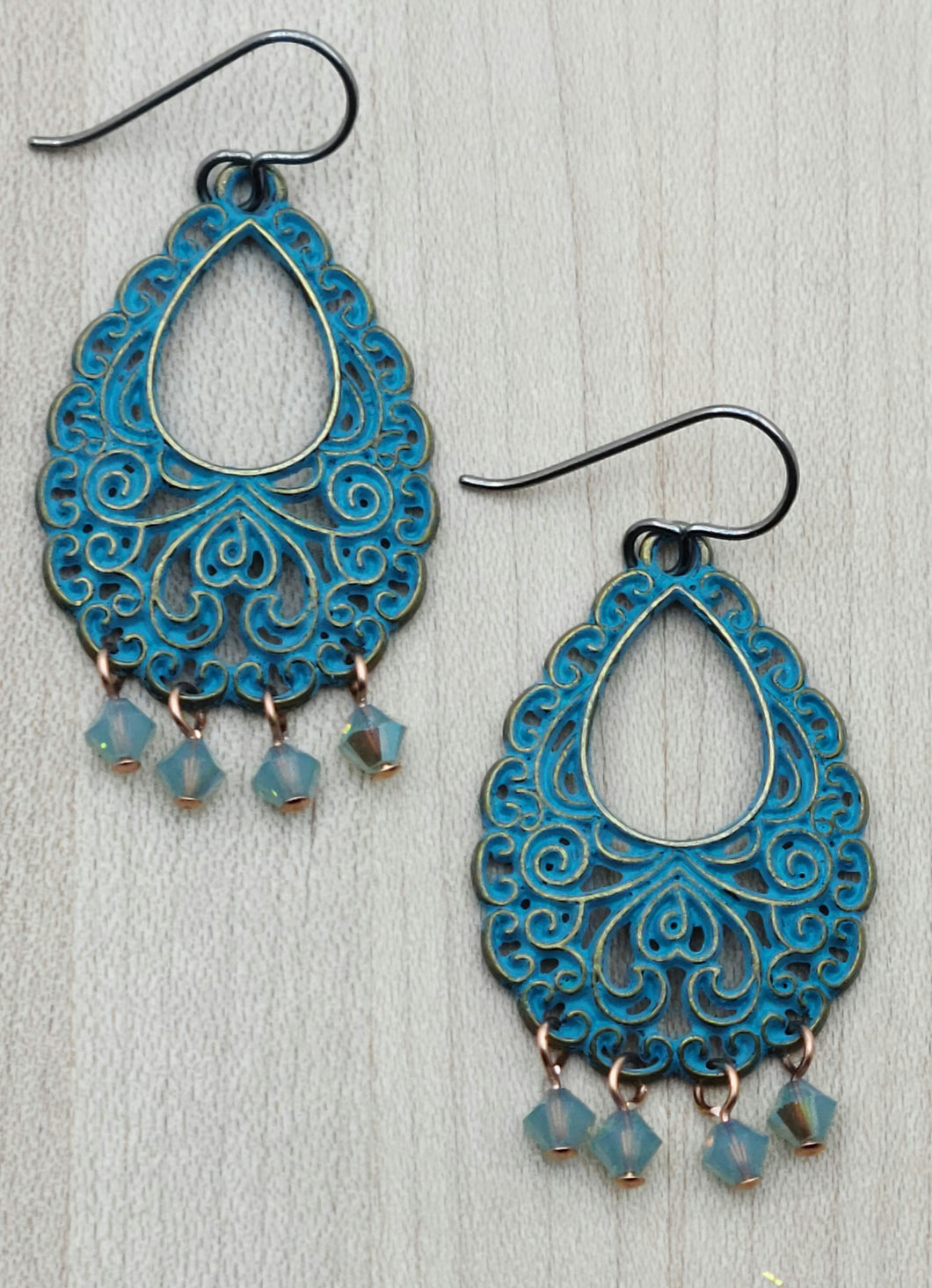 Add a touch of whimsy and fun to your look with these Blue Patina Filigree Teardrop Earrings. 