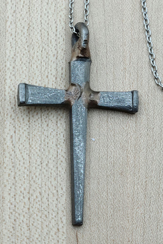 This gender-neutral necklace features a cross made from actual horseshoe nails, suspended on a durable stainless steel chain. 