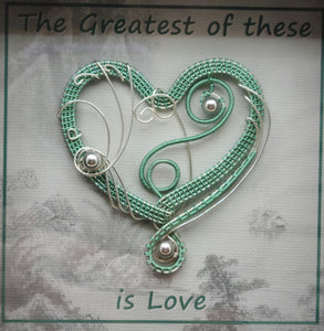 Woven Wire Sea Foam Heart Shadow Box reads The Greatest of these is Love