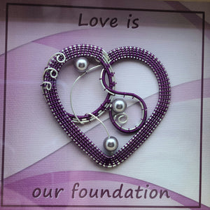 Woven Wire Amethyst Heart Shadow Box reads Love is our foundation