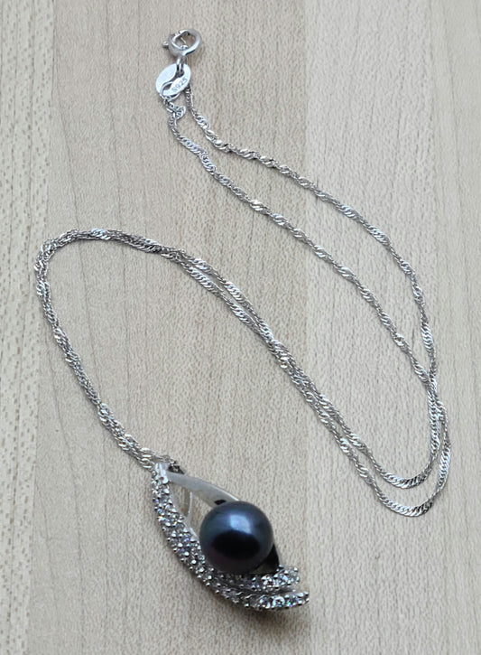 Large 'black' fw pearl mounted in a marquise shaped sterling silver and cubic zirconia setting