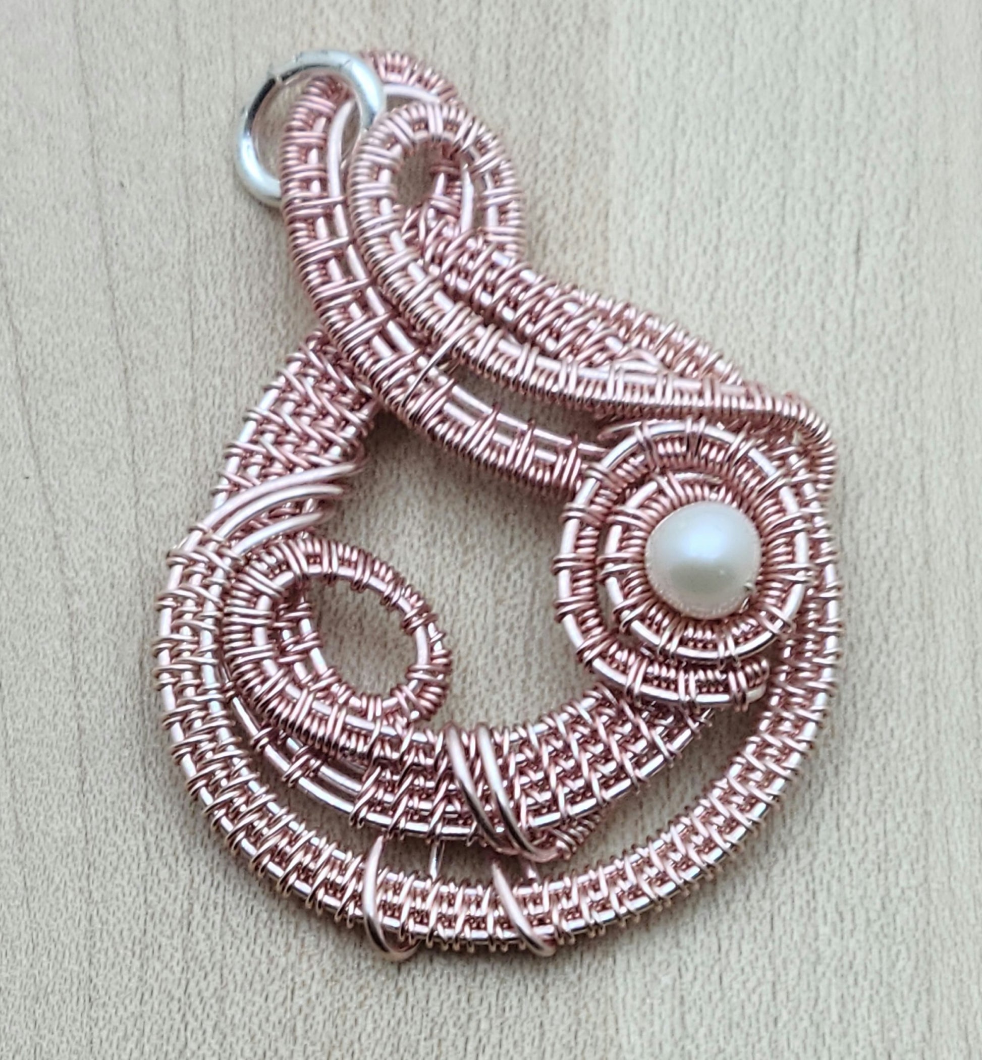 You'll surely garner attention with this rose gold woven wire creation!