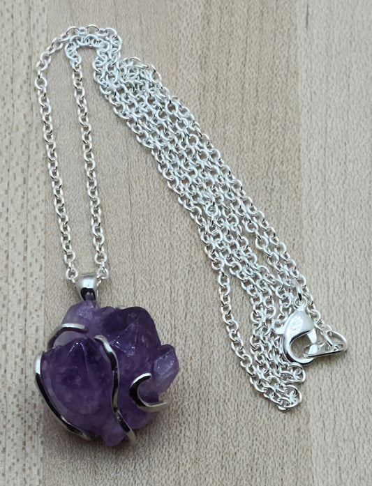 This striking amethyst rock is 'hugged' by a free form sterling silver bail for a very free-spirited look!