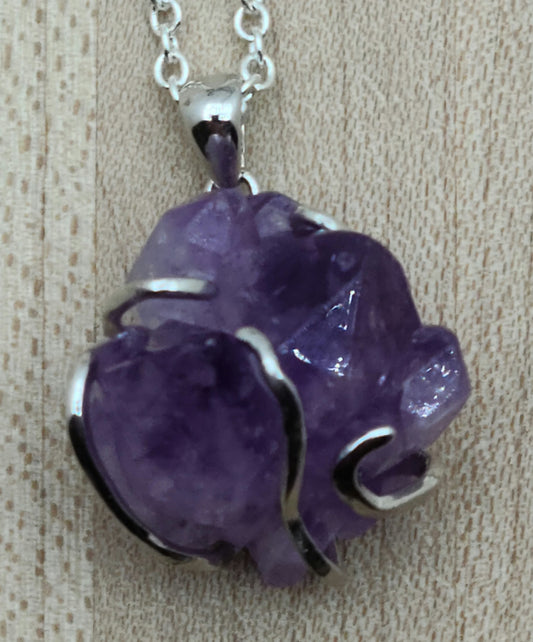 This striking amethyst rock is 'hugged' by a free form sterling silver bail for a very free-spirited look!
