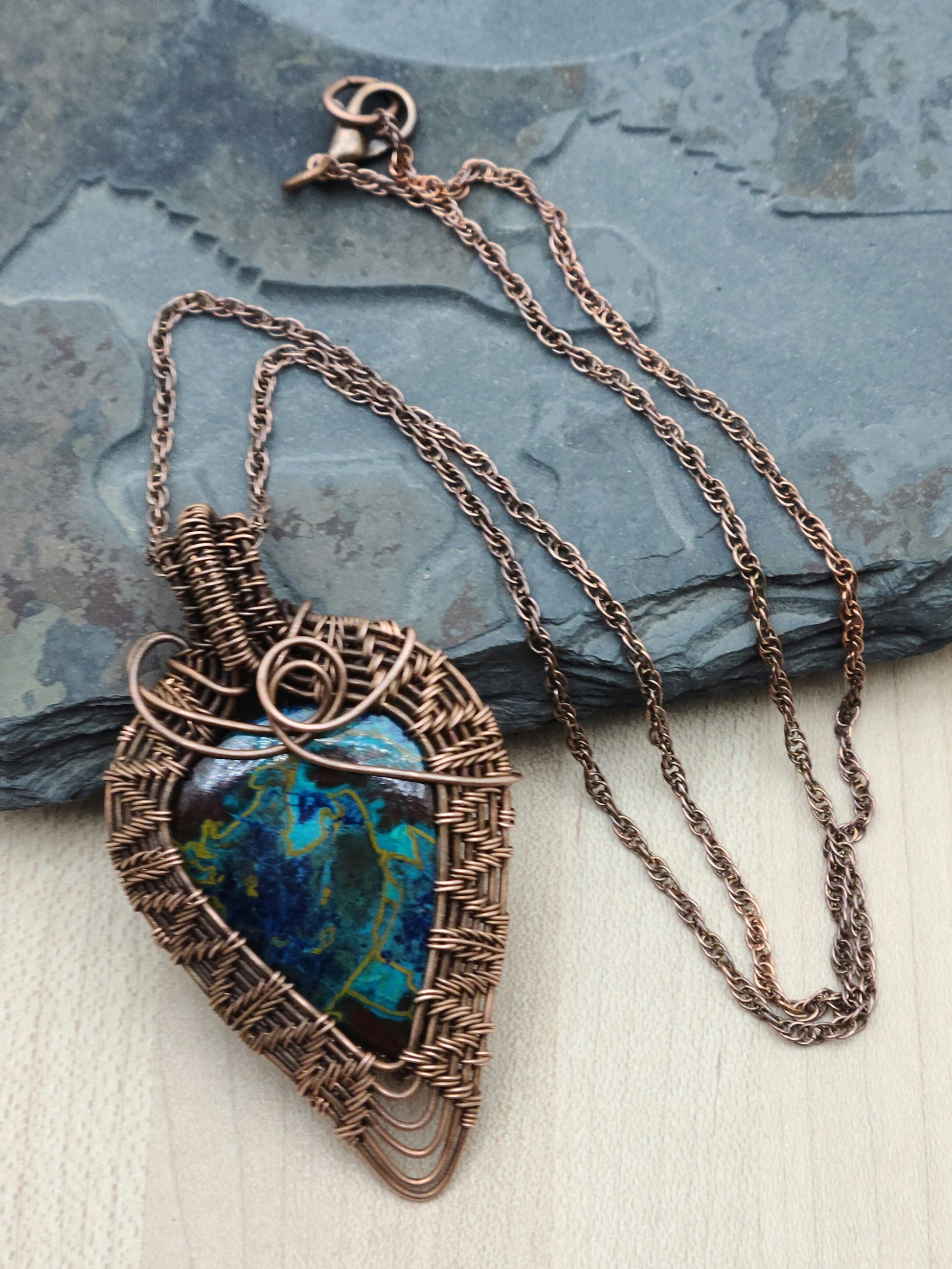 Crysocolla stone framed by antiqued copper wove wire