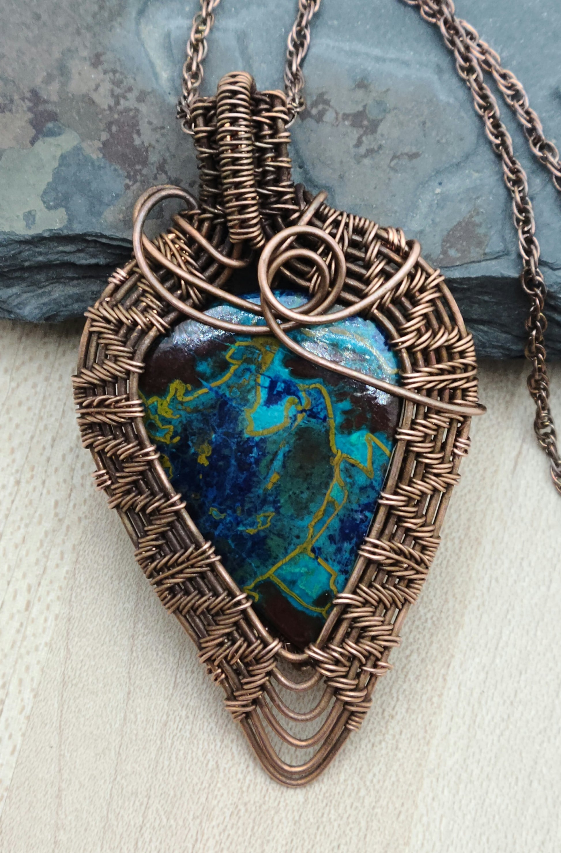Crysocolla stone framed by antiqued copper wove wire