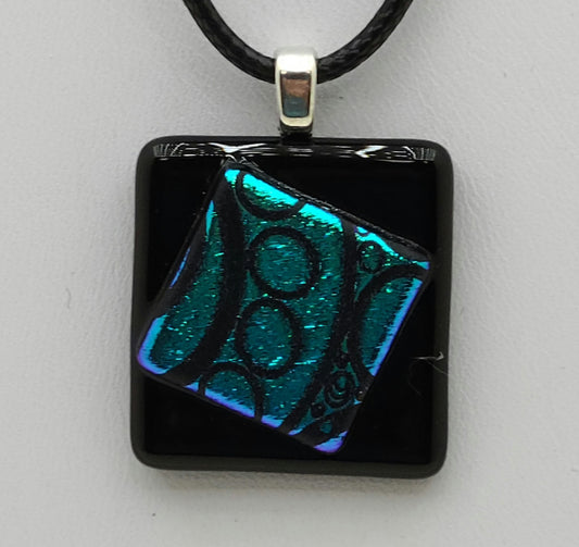 Tiny Cock-eyed teal dichroic square on black square Fused Glass Pendant