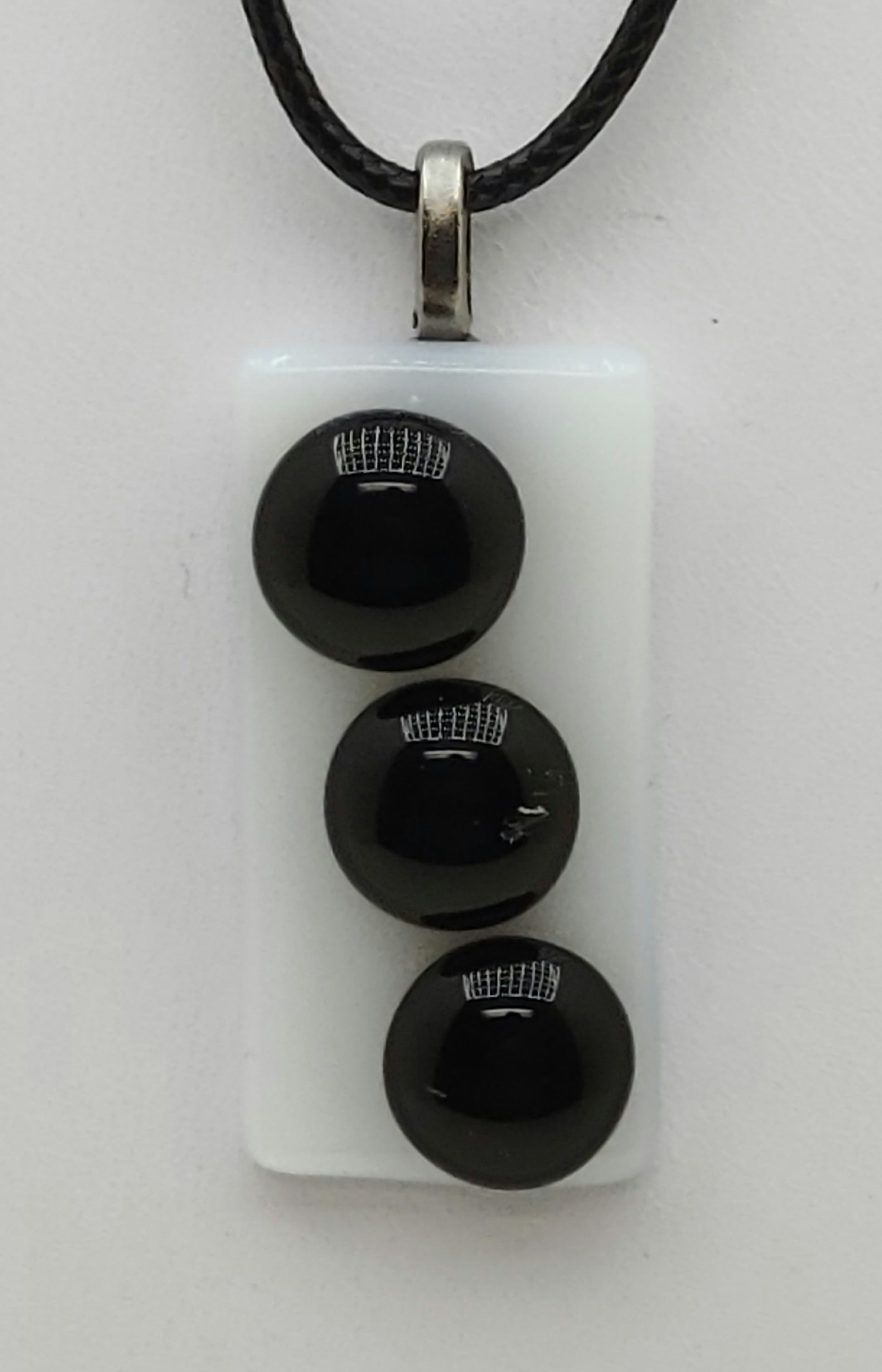 3 black buttons on white background fused glass pedant