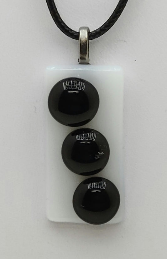 3 black buttons on white background fused glass pedant