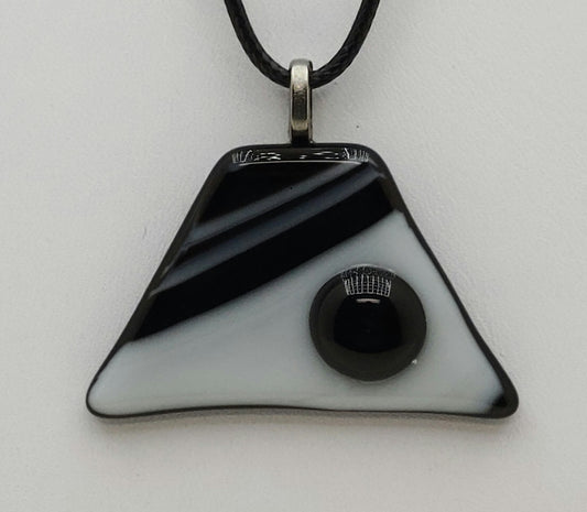 black 'pebble' on black & white background trapezoid fused glass pendant