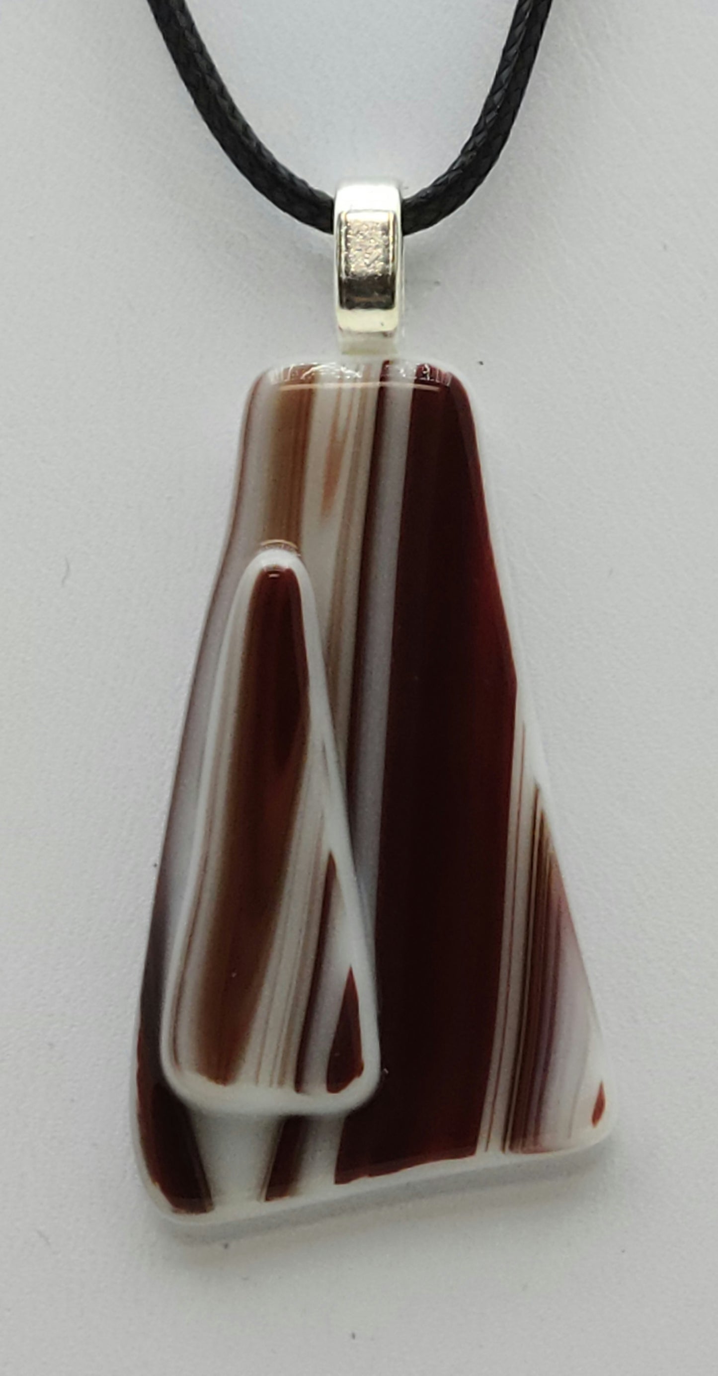 This red  white fused glass pendant bears a resemblance to the beloved peppermint hard candy!