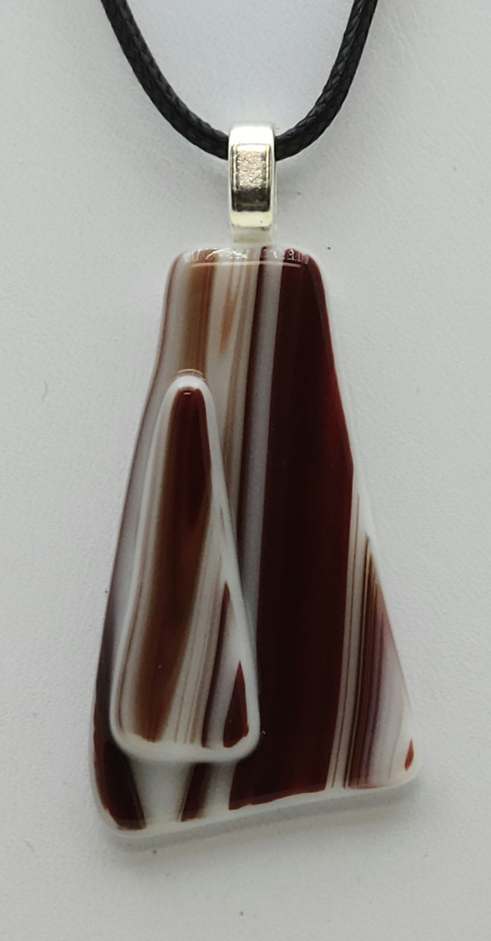 This red  white fused glass pendant bears a resemblance to the beloved peppermint hard candy!