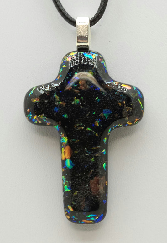 dichroic glass flecks peak through in the fused glass cross pendant.