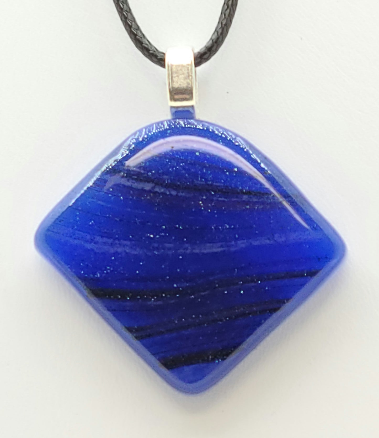 The blue in this fused glass pendant has tiny sparkles in it!