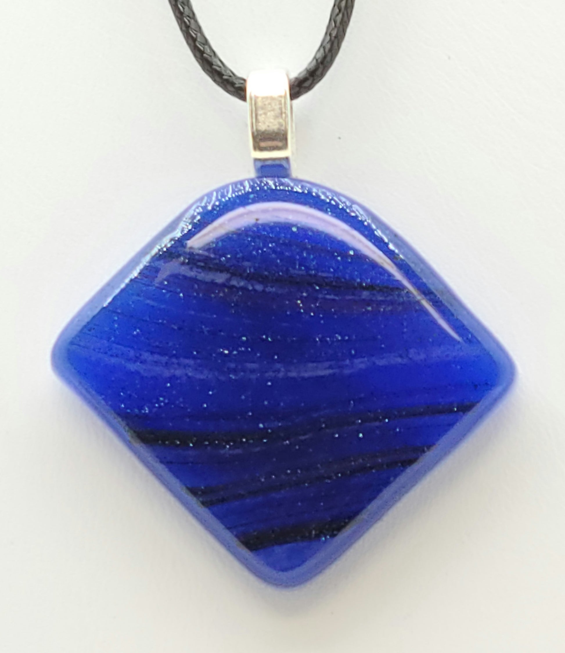 The blue in this fused glass pendant has tiny sparkles in it!