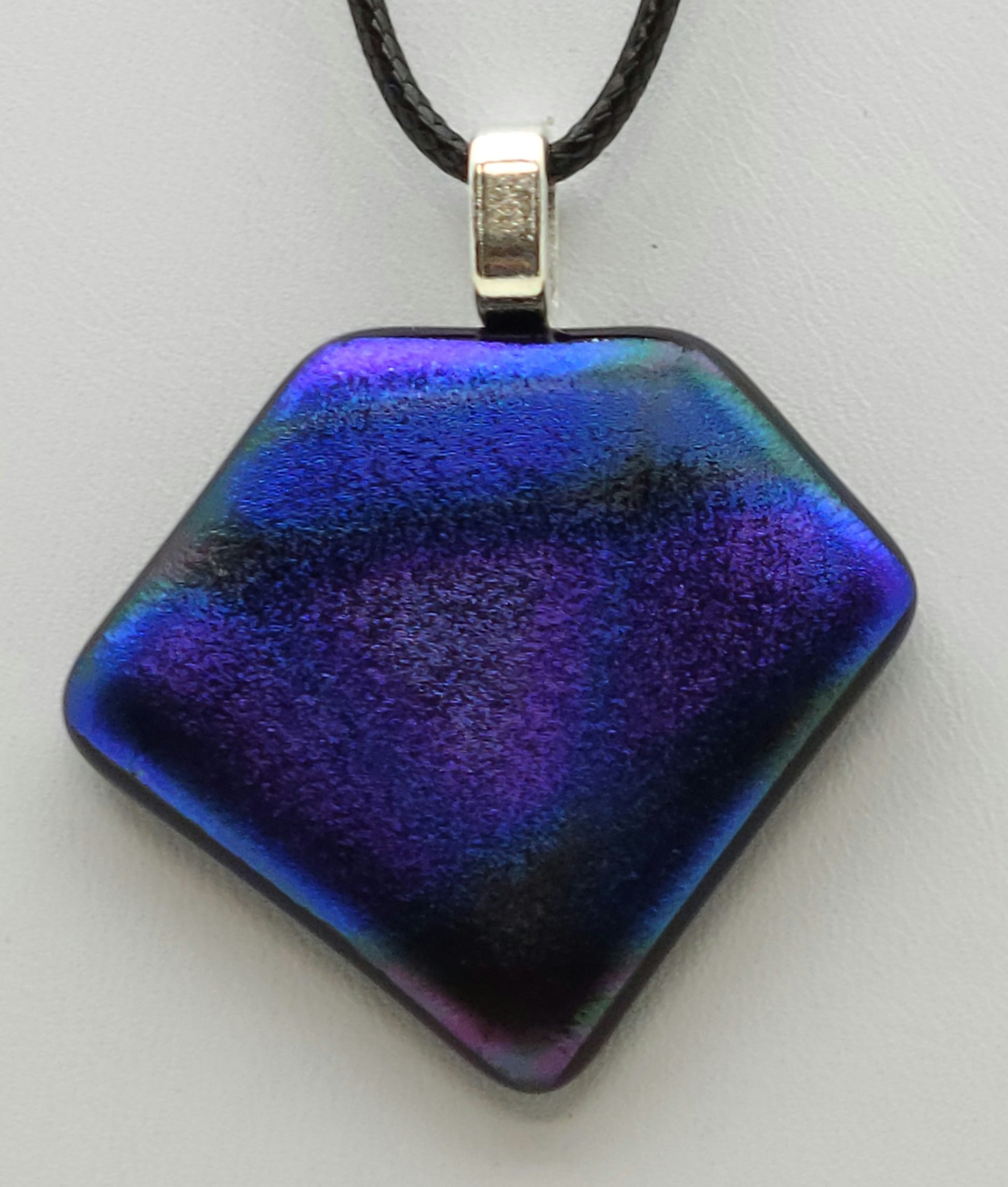 purple & lilac practically glow in this velvety dichroic fused glass pendant.