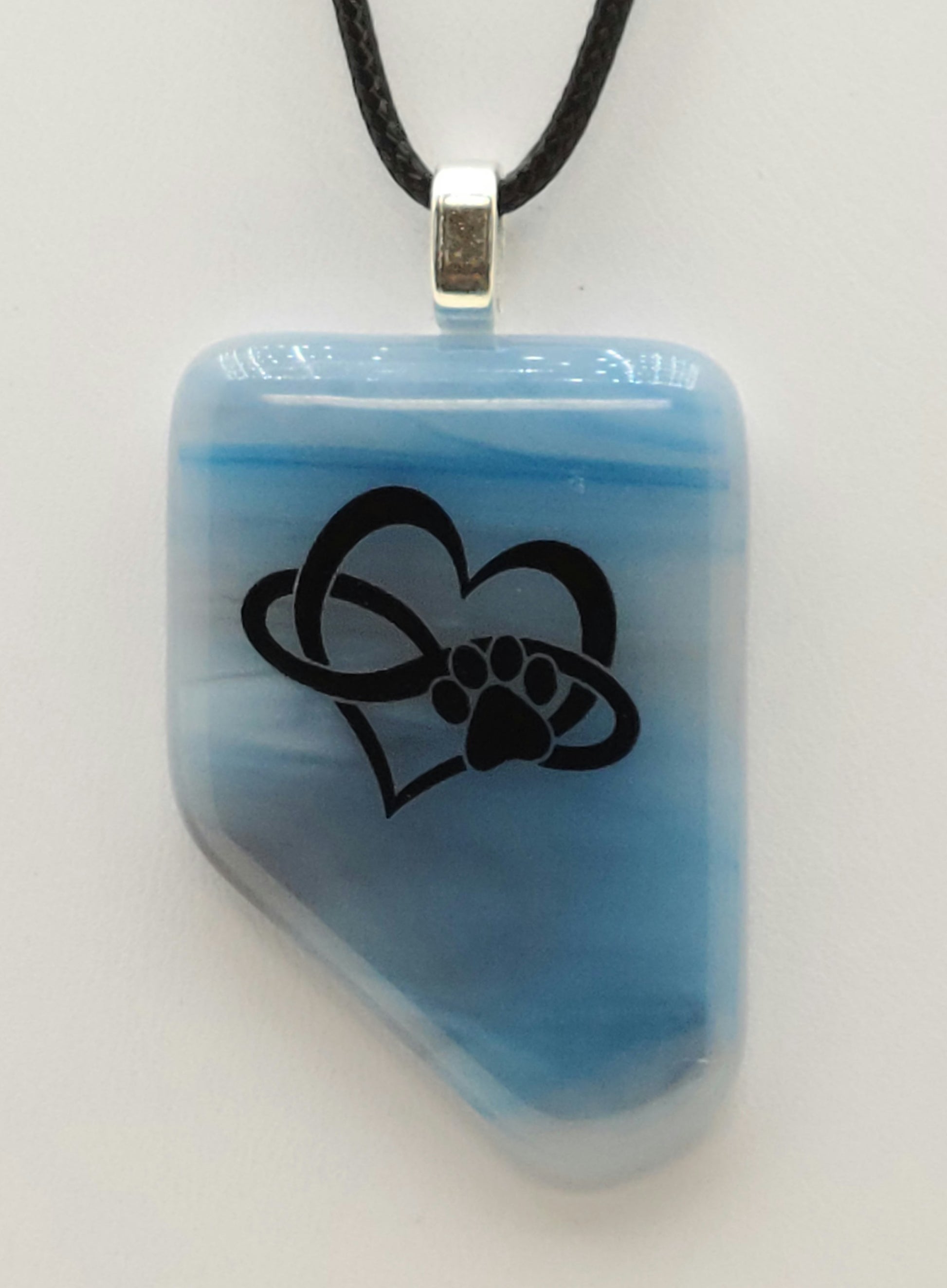 Love your pup to infinity with this heart/infinity/paw on streaky blue fused glass pendant.